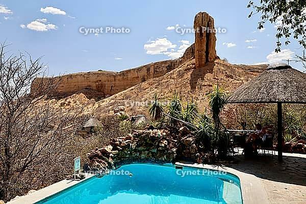 Namibia, Khorixas, Kunene, Vingerklip Lodge, swimming pool, Farm Bertram, Damaraland, behind it plateau Ugab, near Vingerklip, Table Mountain and Cliff, white clouds, blue sky, sedimentary rock [IBR125536433]
