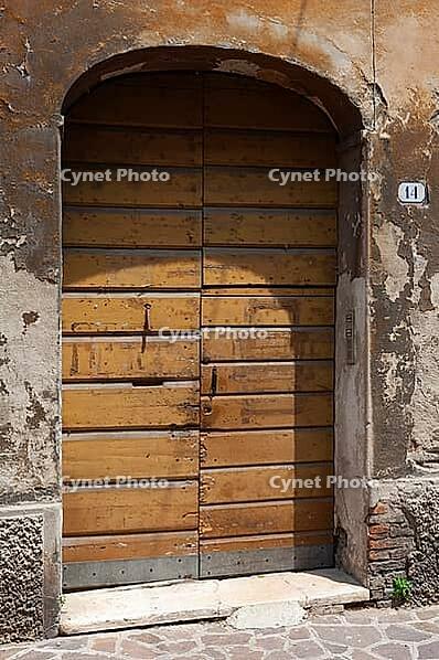 Old patinated door on a dilapidated building, Ravenna, Emilia-Romagna, Italy [IBR125536453]