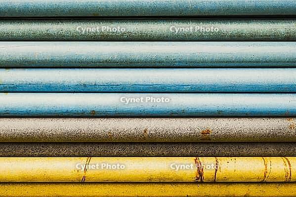 Stacked pipes transition colors blue brown and yellow abstract close up [IBR125536462]