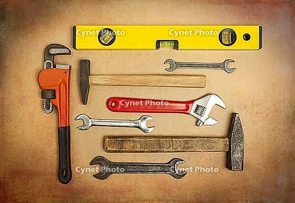 Various tools to work, hammer, tensioner, gas key, level to measure the plane. Close up on a background of craft paper [IBR125557541]