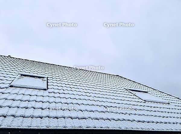 Roof of a house covered in snow on a cold winter day [IBR125557558]