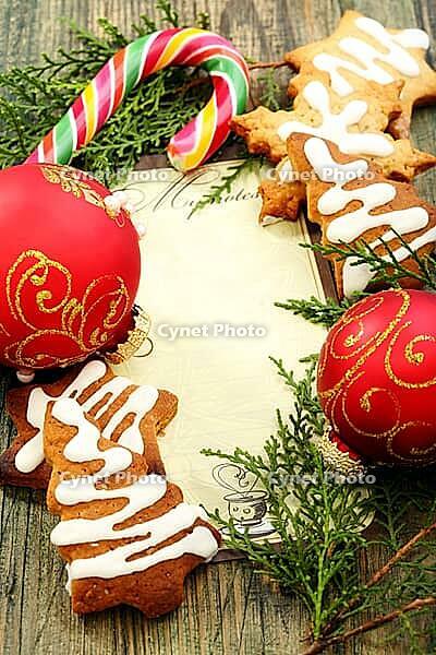 Christmas balls, gingerbread and candy cane on a wooden table [IBR125565987]