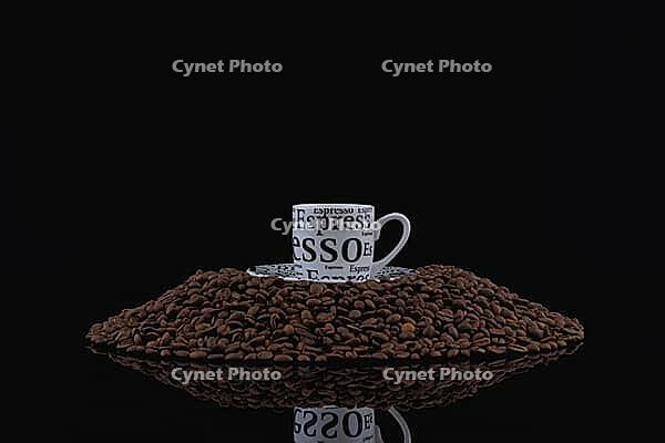 A cup of coffee on a pile of coffee beans [IBR125565990]