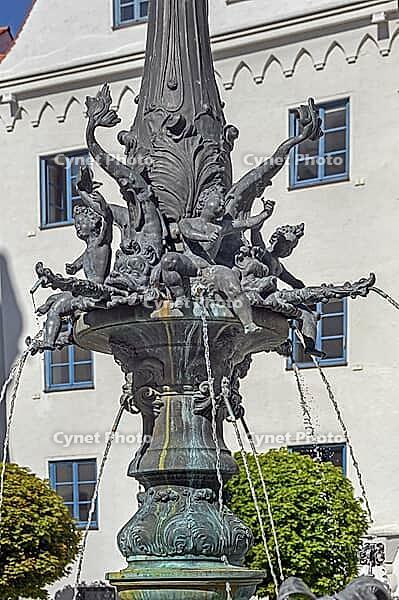 The town hall fountain is a heritage-protected running water fountain, detail of the column, water-spouting putti and dolphins, below the Akanthus leaves, Kempten, Allgäu, Bavaria, Germany [IBR125565995]