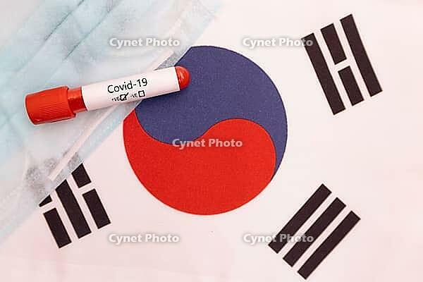 Concept of Novel Coronavirus spreading from China to South Korea - 2019-nCoV or Covid-19 disease positive test on South Korea flag with blood sample [IBR125566005]