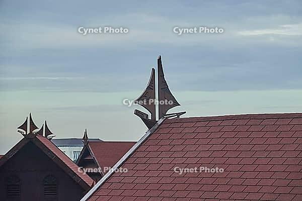 View over saddle roofs decorated with traditional sailboat as roof gable. Makassar, Sulawesi, Indonesia [IBR125566006]