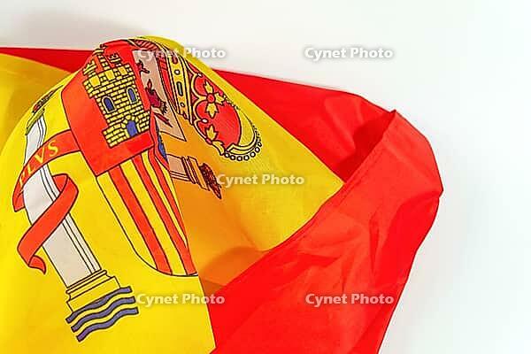 Spanish flag with its distinctive red and yellow stripes and national coat of arms, representing european identity and pride [IBR125566007]