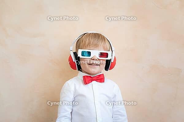 Funny kid wearing 3d glasses. Happy child having fun at home. Retro cinema concept [IBR125566046]
