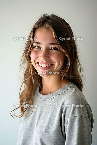 Happy teen girl with long brown hair smiling on a light studio background, AI generated [IBR125592712]