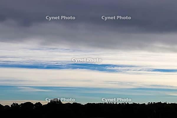 Beautiful panorama of orange and yellow clouds at sunrise and sunset in a blue sky [IBR125606066]