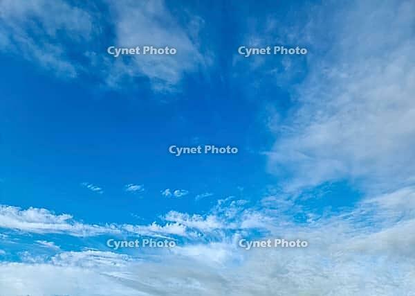 Beautiful fluffy white beautiful cloud formations in a deep blue summer sky [IBR125606070]