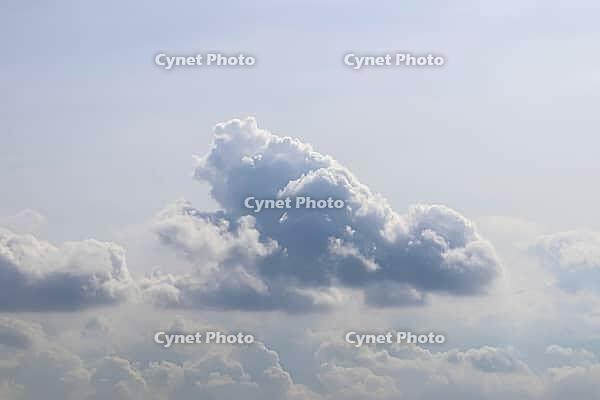 Beautiful fluffy white beautiful cloud formations in a deep blue summer sky [IBR125606071]