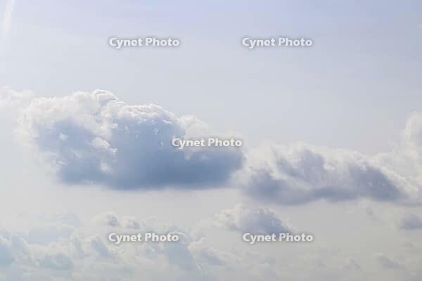 Beautiful fluffy white beautiful cloud formations in a deep blue summer sky [IBR125606080]