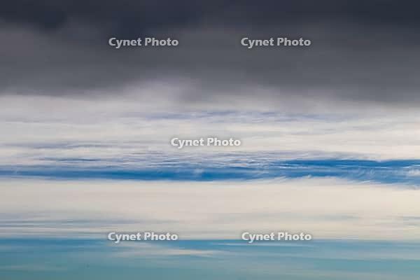 Beautiful fluffy white beautiful cloud formations in a deep blue summer sky [IBR125606084]