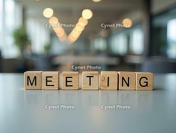Wooden cubes spelling meeting are placed on a reflective table in a blurred office background, symbolizing business communication and teamwork, AI generated [IBR125621284]