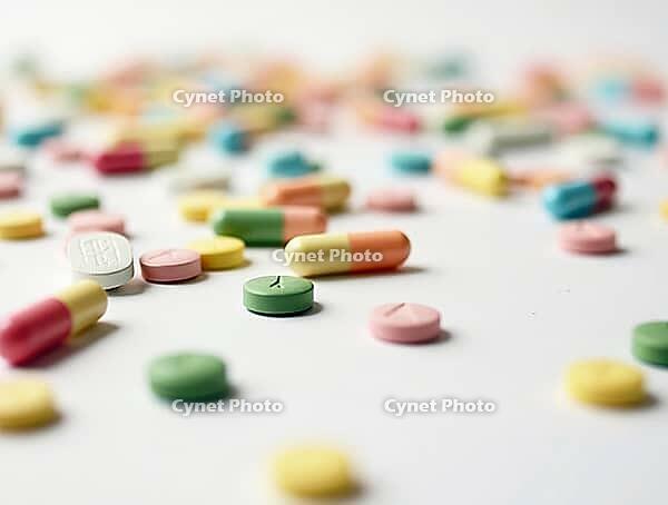 Colorful pills and capsules scattered on a white surface represent the pharmaceutical industry, medicine, and healthcare, AI generated [IBR125621295]