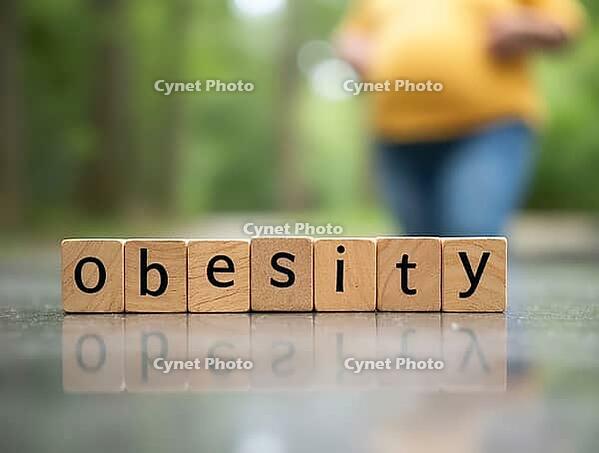 Wooden blocks spelling obesity with pregnant woman exercising in background, illustrating risks of obesity during pregnancy, AI generated [IBR125621320]