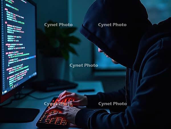 Hacker wearing a hoodie is typing on a keyboard with binary code displayed on a computer monitor, AI generated [IBR125621334]