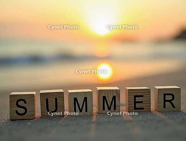 Wooden cubes with the word summer written on them standing on a beach at sunset, AI generated [IBR125621335]