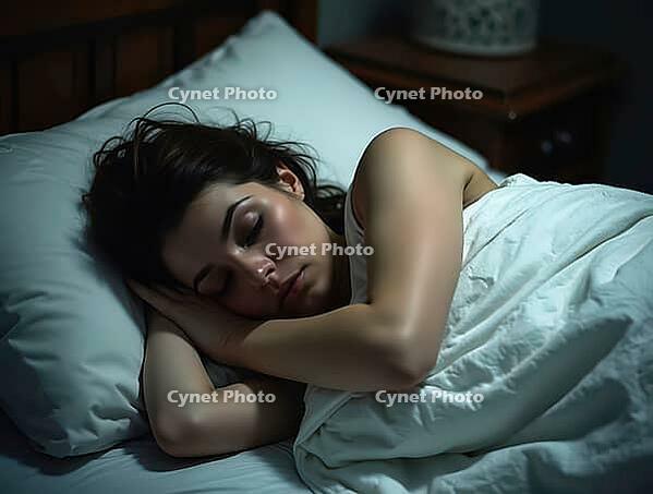 Serene woman enjoying a deep, restful sleep in her comfortable bed at night, AI generated [IBR125621341]