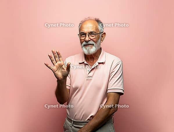 Smiling bearded senior man making stop gesture with hand on pink background, AI generated [IBR125621345]