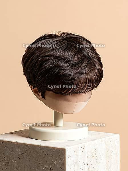 Mens short brown hair wig toupee for balding repair displayed on mannequin head stand on stone block. AI generated [IBR125621366]