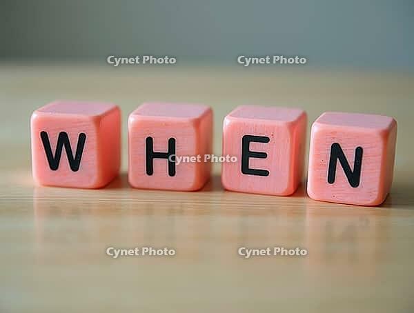 Four pink cubes with black letters form the word when on a wooden table, AI generated [IBR125636886]