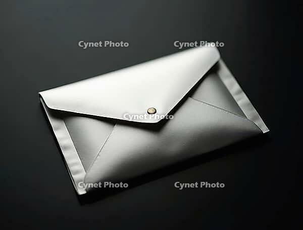 Closed silver envelope on a black table, representing style and sophistication, AI generated [IBR125636892]