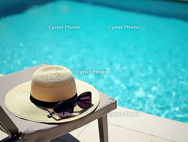 Straw hat and sunglasses are placed on a deck chair near a beautiful blue swimming pool, embodying the essence of summer relaxation and vacation bliss, AI generated [IBR125636897]