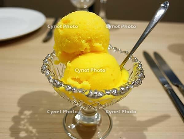 Refreshing saffron and rosewater sorbet presented in a crystal bowl, ready to be enjoyed, AI generated [IBR125636908]