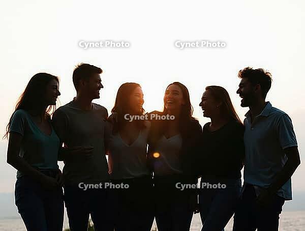 Silhouetted friends enjoying a moment of laughter and togetherness at sunset, AI generated [IBR125636909]