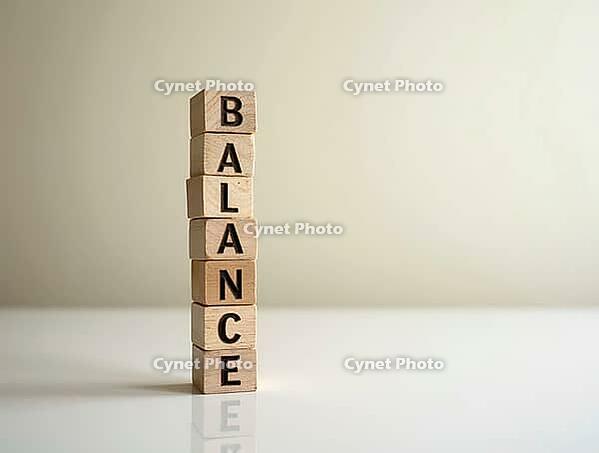 Wooden blocks stacked vertically, spelling the word balance, on a reflective white surface, emphasizing stability and equilibrium, AI generated [IBR125636924]