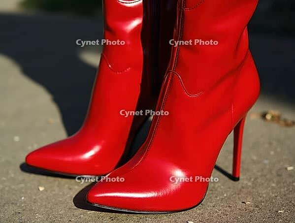 Close-up of glamorous shiny red patent leather high heel boots standing on gray pavement, AI generated [IBR125636935]
