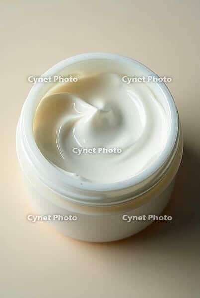 Cream jar showcasing a smooth, artistically swirled texture, AI generated [IBR125636940]