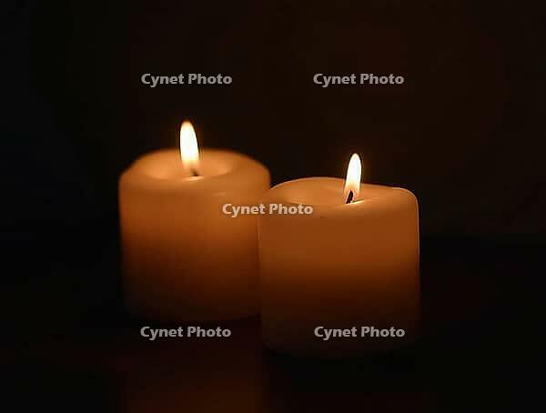 Two lit candles providing a warm glow in a dark environment, perfect for solemn occasions, AI generated [IBR125636958]