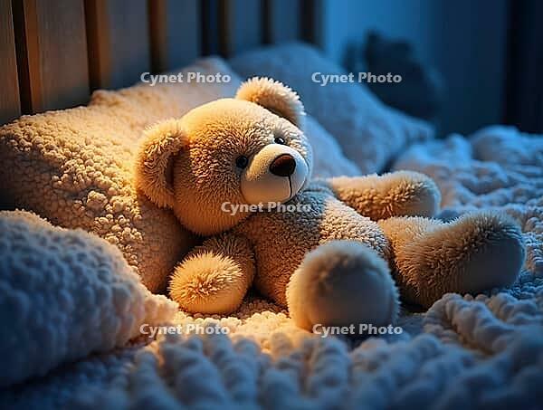Cute teddy bear resting in a cozy bed, enjoying a peaceful night's sleep under soft, warm lighting, AI generated [IBR125645873]