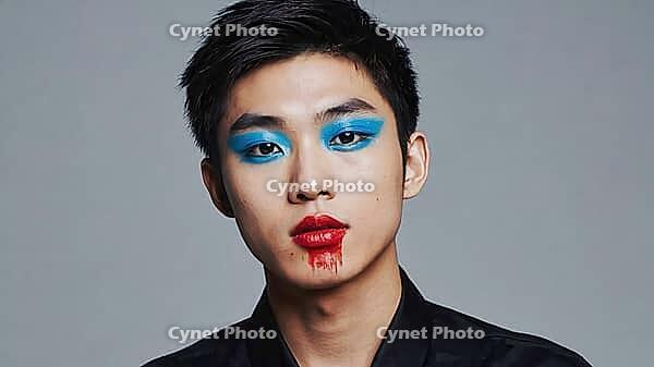 Portrait featuring a model showcasing vibrant blue and red makeup against a textured gray background, highlighting contemporary beauty and style, AI generated [IBR125653425]