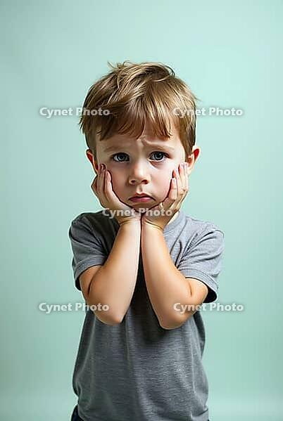 Portrait of disappointed preschooler holding face with hands on light green studio background, AI generated [IBR125653444]