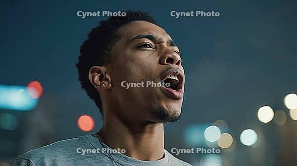 Young man shouting with an open mouth in a city at night with blurred lights in the background, AI generated [IBR125653472]