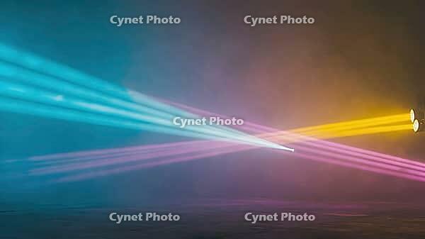 Colorful light beams are crossing in a smoky atmosphere, creating a vibrant and dynamic stage lighting setup, AI generated [IBR125653474]