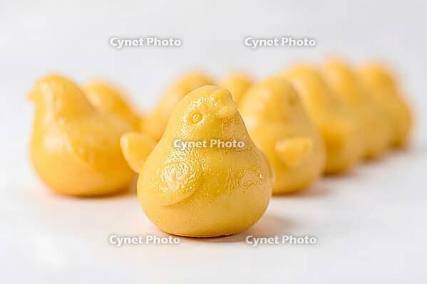 Golden yellow chick shaped buns in a row, Hiyoko manju, Chick shaped manju, white bean paste and sponge, Fukuoka, Kyushu, Japan, dessert, confectionery, food photography, AI generated [IBR125653477]
