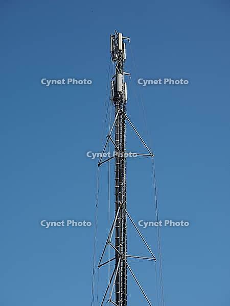 Cellular antenna tower and electronic radio transceiver equipment part of a cellular network over blue sky [IBR125654812]