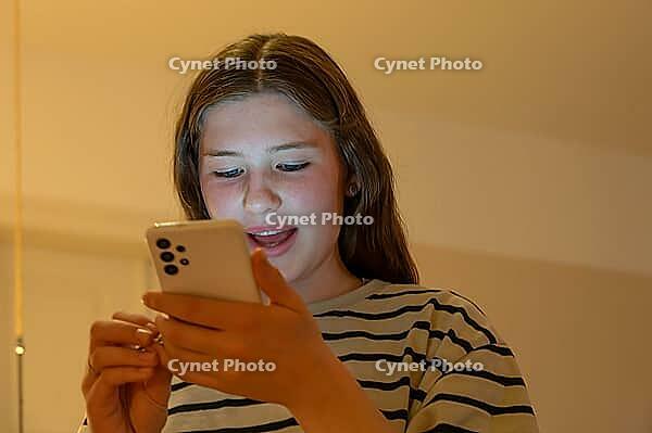 Young girl, teenager on mobile phone, Mecklenburg-Western Pomerania, Germany [IBR125657375]
