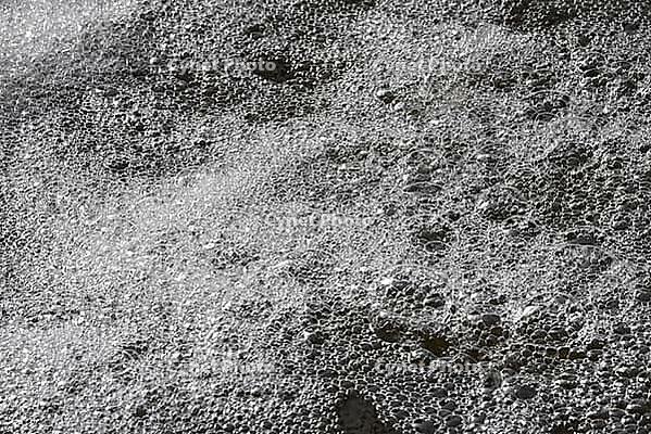 A closeup shot of a water surface covered by multiple fragile bubbles [IBR125657380]