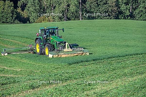 Tractor and large mower of the Köchesldorf agricultural cooperative mowing grass, Othenstorf, Mecklenburg-Western Pomerania, Germany [IBR125657415]