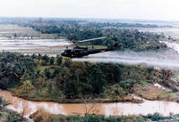 A US Huey helicopter spraying agent orange during Operation Ranch Hand, c. 1965. [UIG110171002]