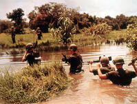 16th Armored Division members cross a jungle river in previous Viet Cong territory. Vietnam, 9/65. [UIG110171003]