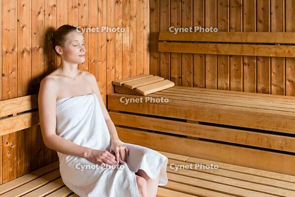 Woman in wellness spa enjoying sauna. [UIG110170925]