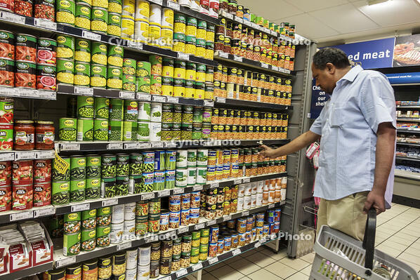 Pick n Pay grocery store shelves display canned vegetables man shopping [UIG110171049]