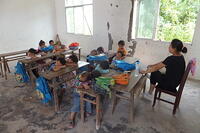 The most arduous sleep: Mountain village students napping at their desks. [IMC111460083]